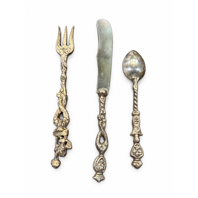 A charming collection of three coordinating boxed Italian silver-plated flatware sets dating to approximately the 1960s....