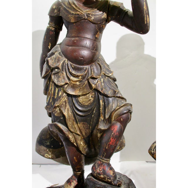 Japanese carved wood and lacquered guardian figures. 17th -18th century, one showing glass eyes. Made in several sections...
