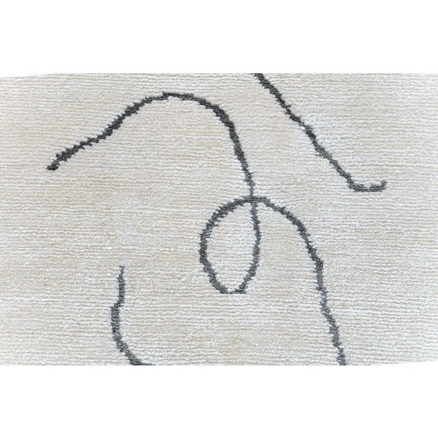 This modern abstract runner presents a refined, minimalist composition of free-flowing, calligraphic lines scattered...
