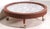 Unusual Mid Century 1950's coffee table, having a faux marble formica top, surrounded by an upholstered rim, mounted on...