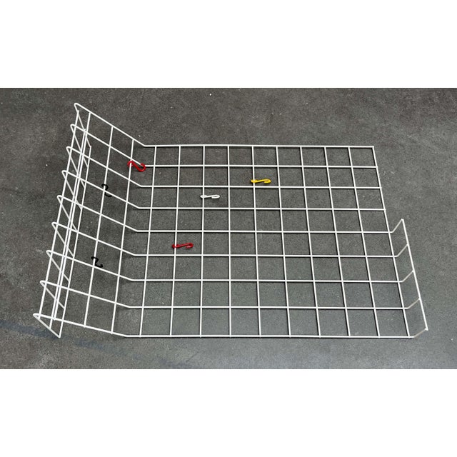 Minimalist mid-century wire coat rack. Simple coat rack made of coated metal mesh. The upper section and part of the lower...