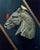 The artwork features a sculptural representation of a horse's head rendered in muted tones, juxtaposed against a dark...