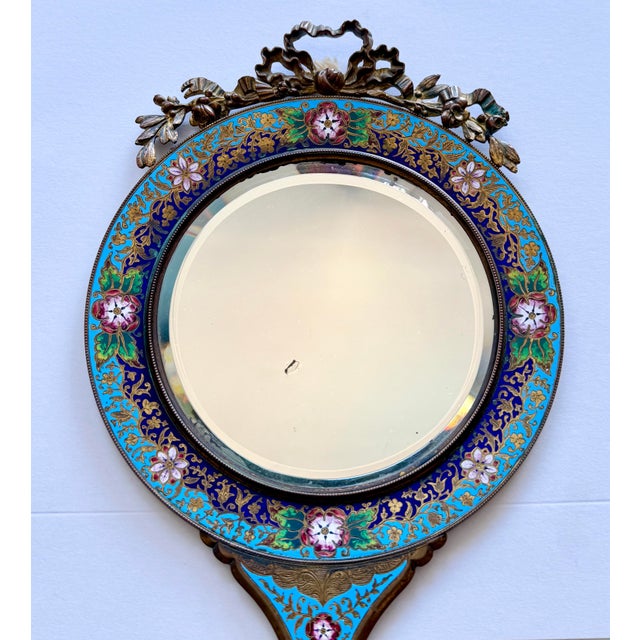 This fabulous 19th century circular-shaped beveled mirror, featuring Champlevé enameling with a floral design, is approx...