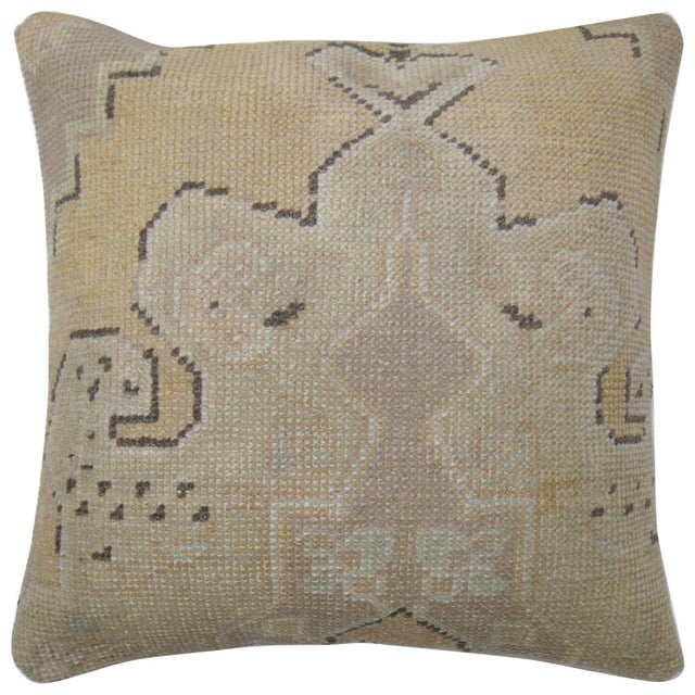 Pillow made from a vintage Oushak rug. Tan, light green medallion, brown outline accents. 18'' x 18''