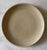 Set of 4 vintage mid century small stoneware plates with a hefty weight and substantial lip and warm tan/oatmeal glaze....