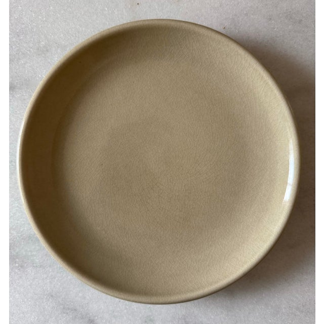 Set of 4 vintage mid century small stoneware plates with a hefty weight and substantial lip and warm tan/oatmeal glaze....