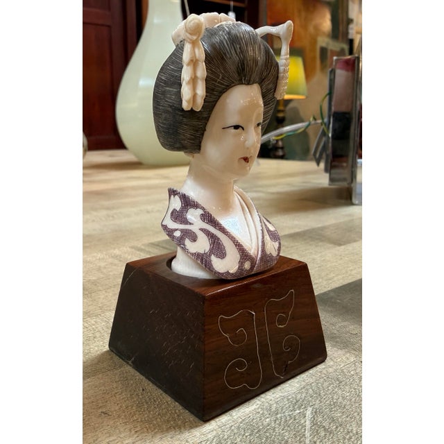 Design Plus Gallery presents a Signed Geisha Sculpture on a Stand. This finely detailed vintage Japanese female bust with...