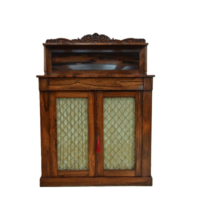 Very attractive william iv / early victorian two door rosewood sideboard of unusually narrow proportions, having carved...