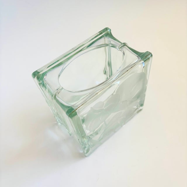 A unique vintage vase made from a glass block. A rounded rectangular opening has been cut into the top for use as a vase....