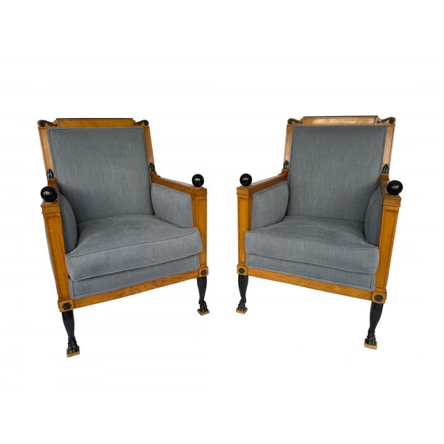These elegant French Consulat bergères are masterfully crafted from warm-toned mahogany, punctuated with ebonized brass...