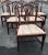 up for sale are antique one arm and five side chairs; the chairs have a foliate carved back rail over an interlaced...