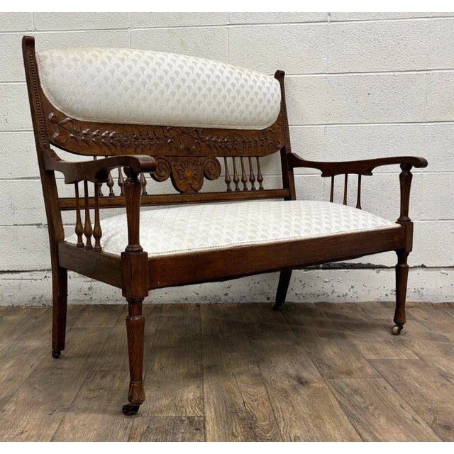 This is a stunning antique, believed to be Edwardian from the early 1900s, carved spindle back carved upholstered settee...