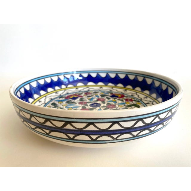 This vintage 1980's Jerusalem art pottery hand painted multicolor floral artisan ceramic decorative serving bowl is a very...