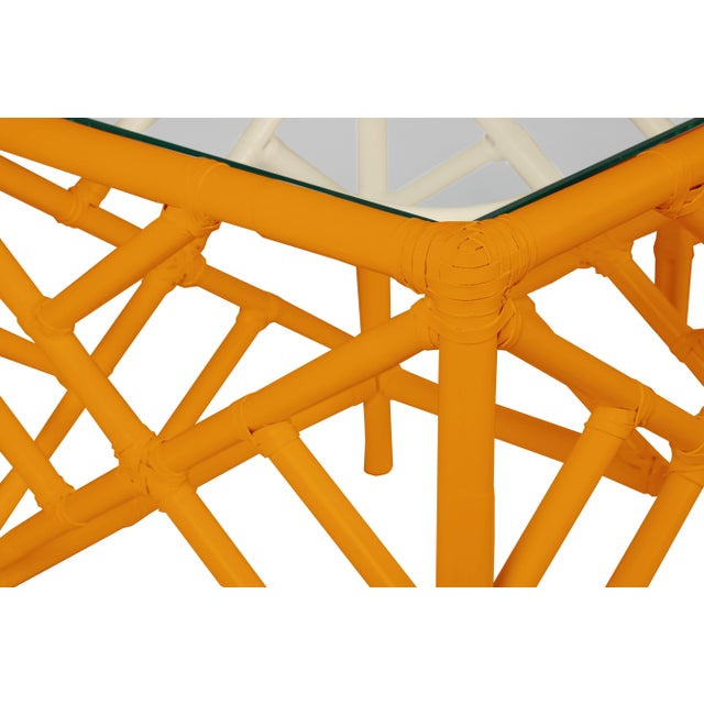 In a classic chinoiserie style, this set of two rattan nesting tables feature a rattan frame, rawhide bindings, hand...