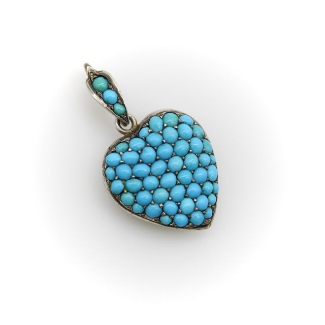 This heart-shape Victorian sterling silver locket is encrusted with pave turquoise cabochons that fill its entire front...