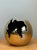 Sculpted with a dynamic, fractured spherical silhouette and bold metallic presence, this vintage mid-century modern cast...