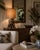 Elegant sculptural driftwood-style table lamp featuring an organic intertwined wood-form base paired with a classic...