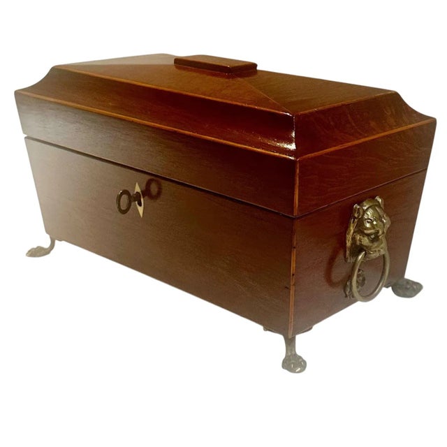 A distinguished English Regency tea caddy, likely dating to the 1830s, featuring a red leather lined interior and a velvet...