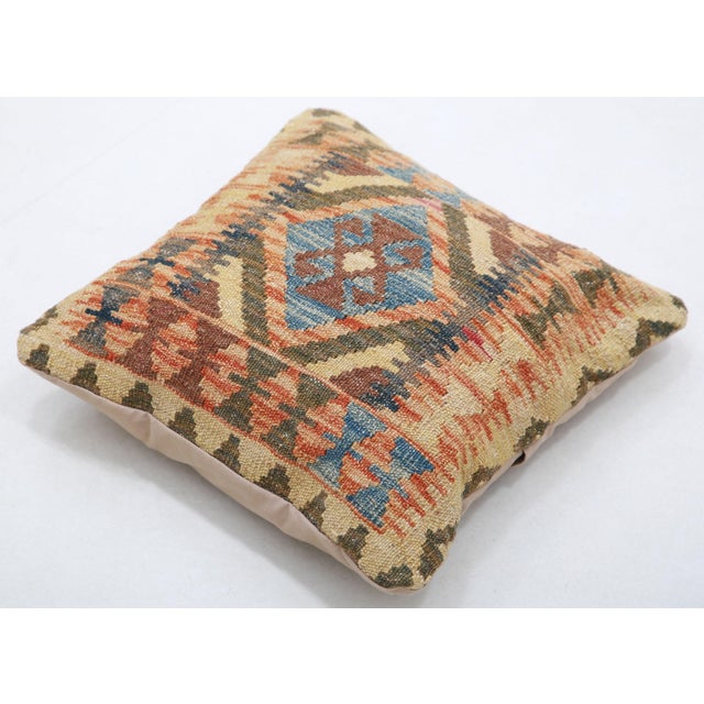 A one-of-a-kind handwoven Afghan wool kilim accent pillow featuring hooked diamond medallion on tan. Cut and sewn by hand...