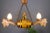This interesting and unusual hand-carved wooden chandelier features a centered large wine barrel and a wooden figurine of...