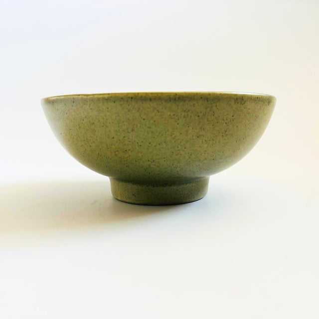 A vintage pottery bowl by Haeger finished in a lovely speckled green glaze. Slightly elevated on a pedestal base. Perfect...