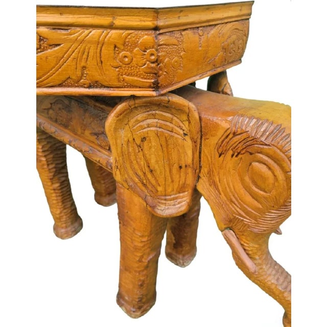 A solid wood custom made hand carved elephant side table . The table has been hand carved in a rustic manner. It's made of...