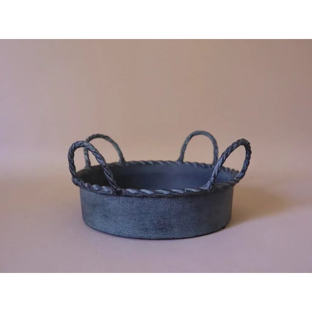 Metal basket with braided handles and rim. Pretty green patina. Shallow, for decorative use only.