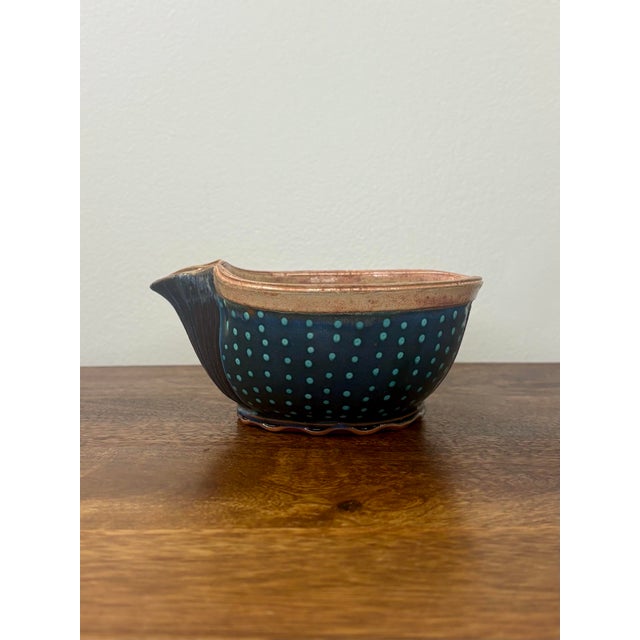 A beautifully handcrafted vintage studio pottery pouring bowl featuring a rich cobalt-blue glaze decorated with rhythmic...