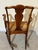 Antique wooden rocking chair featuring a Queen Anne style design with cabriole legs and a woven rush seat. Style: Queen...