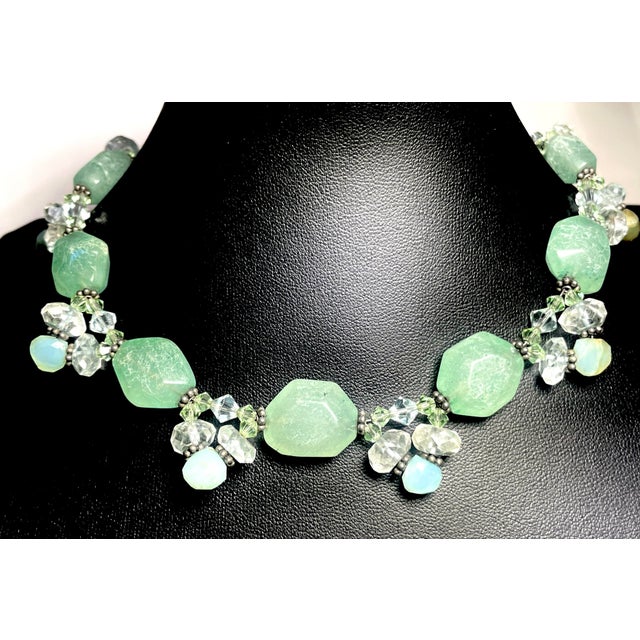 This necklace combines several prized gemstones in a harmonious palette of blue, green, and yellow tones. Moss Aquamarine,...