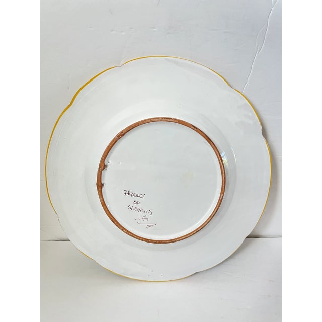 Hand-painted ceramic serving bowl with scalloped edge. Made in Slovakia. Features a bird and floral motif. Perfect for...