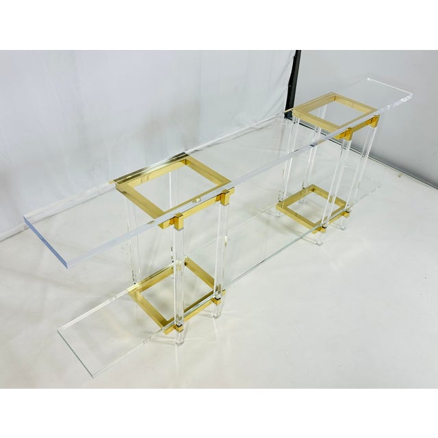 Add a touch of glamour to your home with the Brass & Lucite Console Table by Charles Hollis Jones from the Metric...