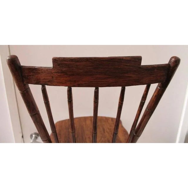 Early 19th century painted child's Windsor chair in good condition. The chair has a second generation painted surface.