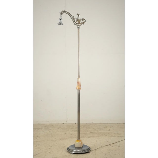 1920s-1930s floor lamp with a mythic figural theme centered on the hippocampus motif at top. A marbled celluloid grip on...