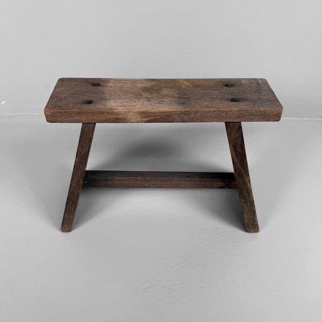 Rustic Japanese wooden stool dating from 1950–1960, featuring a simple design and a warm, timeworn patina. Dimensions: H...