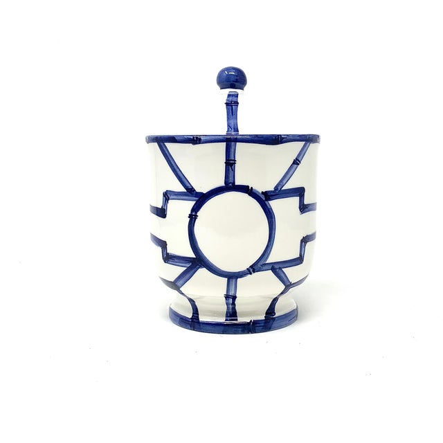 Ceramic vanity set in a bamboo fret pattern, glazed in navy. Includes a lidded cotton jar, soap dish, and tumbler....