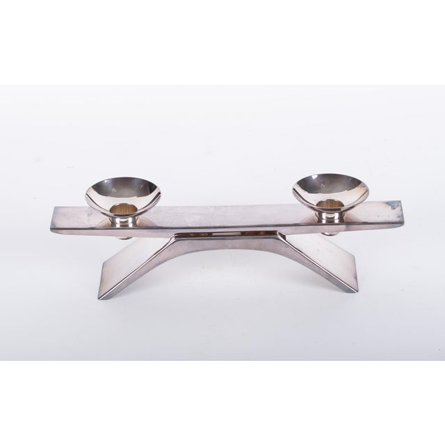 A Mid-Century Modern silver-plated candle holder designed by renowned Bauhaus designer Wilhelm Wagenfeld and produced by...