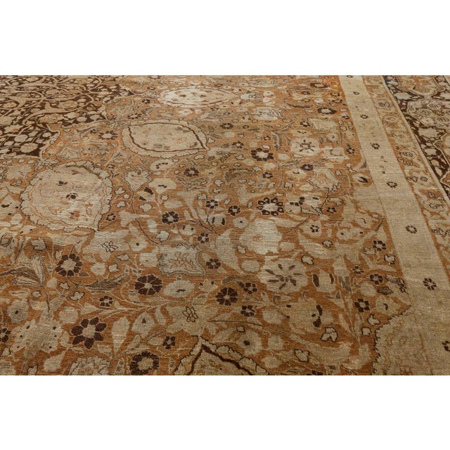 A majestic masterpiece of 19th-century Persian craftsmanship, this oversized antique Tabriz rug exudes refined elegance,...