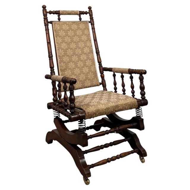 A handsome and well-crafted early 20th-century American rocking chair, constructed from beech and combining traditional...