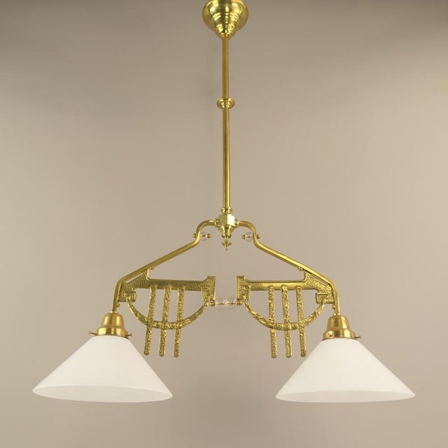 This two-armed hanging lamp for the dining or gaming table is a beautiful example of the Art Deco era. The lamp is...
