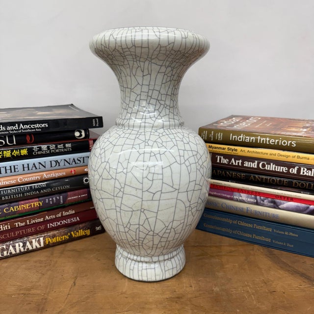 "About This Piece About This Piece This vase captivates with its elegant white glaze, patterned by a striking web of dark...