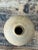 This vintage ceramic vessel embodies the understated warmth of mid-20th-century studio pottery, its rounded form finished...