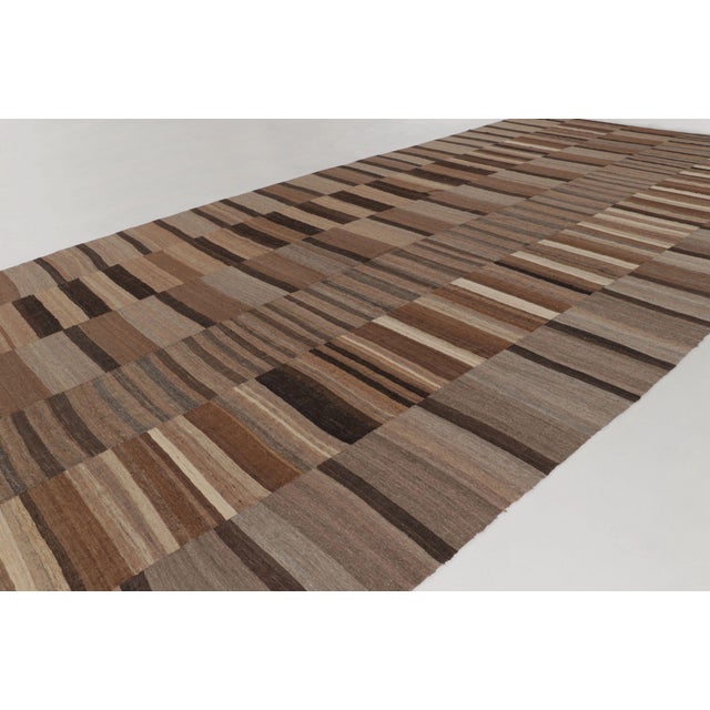 Handwoven in wool circa 1950-1960, this oversized vintage 12x23 Persian kilim runner features a classic flatweave...