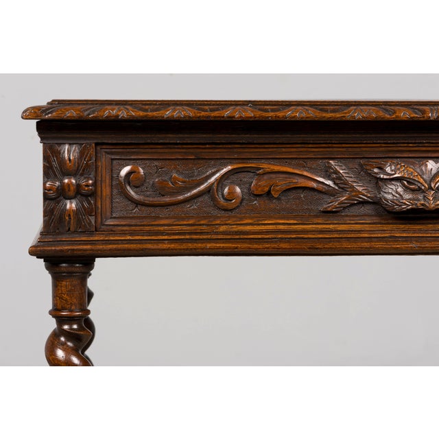 A late 19th-century French oak writing table in the Henry II style, sourced in Provence, France. The table has been...