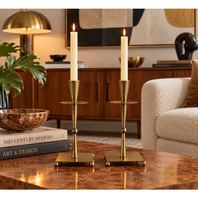 Striking pair of 1970s Mid-Century Modern candle holders crafted in brass and metal with a sculptural geometric design....
