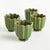 In a classic silhouette with petal edges, these footed mini pots are natureinspired. Finished in a rich verdant green...