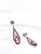 These stunning Art Deco-inspired drop earrings feature an elegant elongated teardrop silhouette set in gleaming white gold...