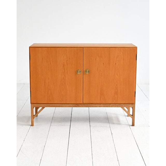 Model "232" oak sideboard with hinged doors and brass handles. Designed by børge mogensen and produced by fdb, denmark,...