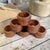 These are wooden napkin rings, vintage / mid-century modern set, used to hold cloth napkins for table settings. They have...