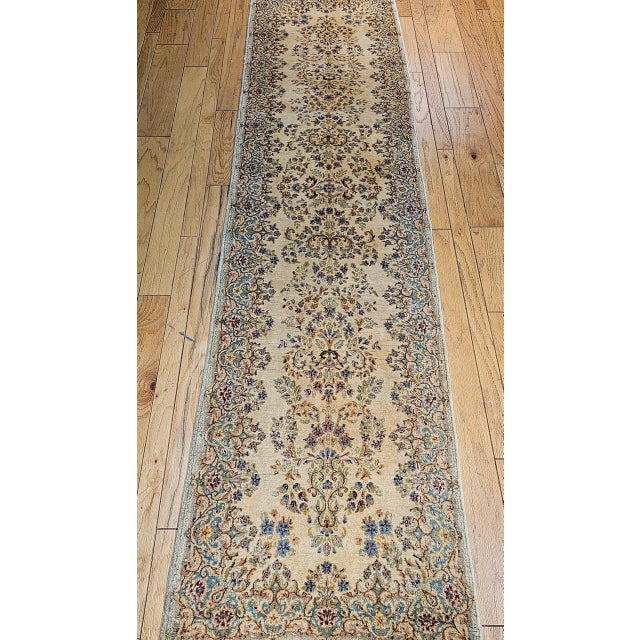 "Discover the refined elegance of this captivating Vintage Persian Kerman Runner, a testament to the celebrated weaving...